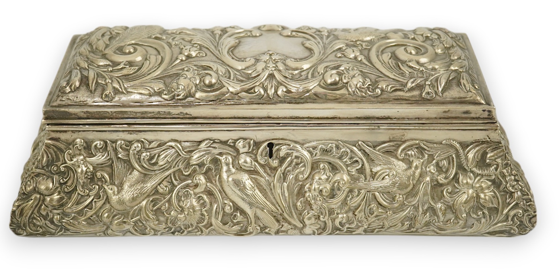 An Edwardian repousse silver mounted jewellery casket, by William Comyns